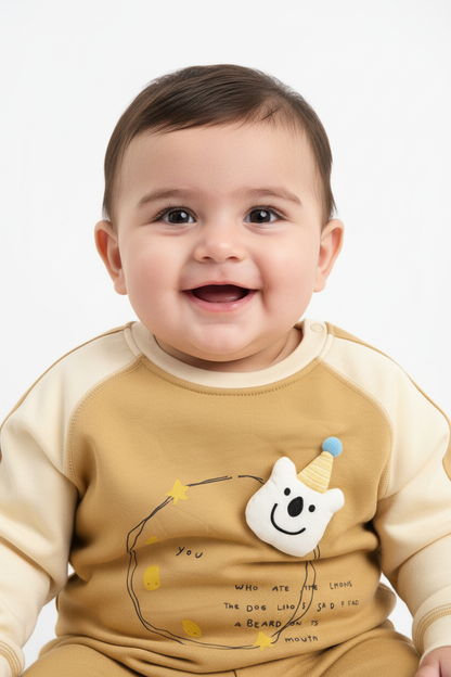 Close-up of child in mustard yellow romper showing bear design